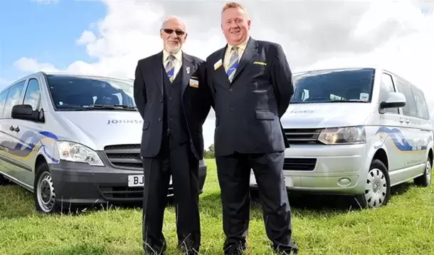 Coach drivers infront of coach